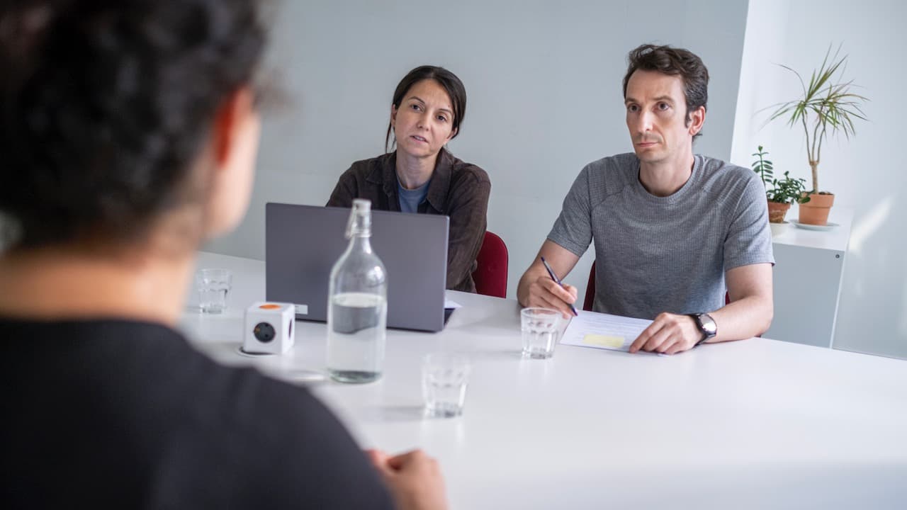 Three people sitting in a job interview