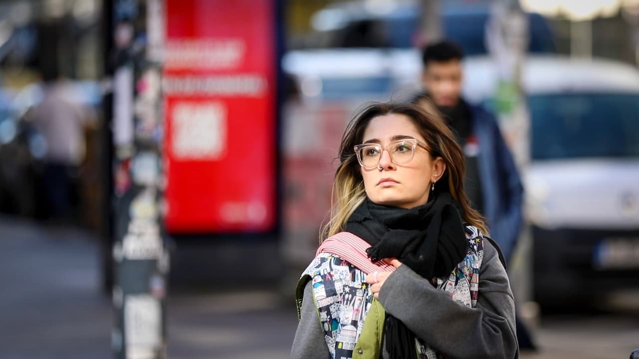 Young women passing the street, looking to the right