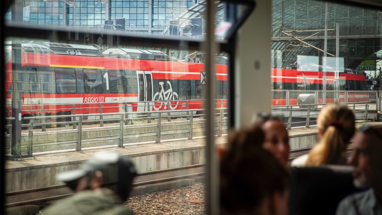 Passengers in a train with a view of the station