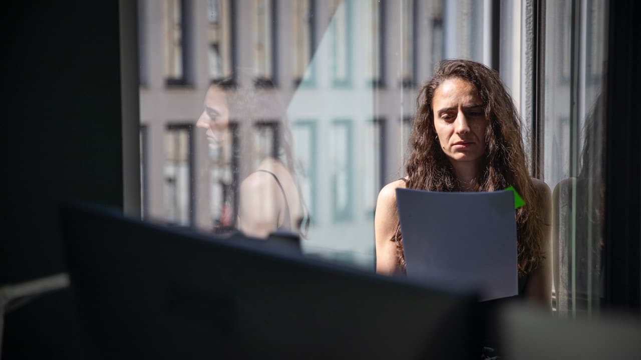 Woman at work reading a document with concerned expression