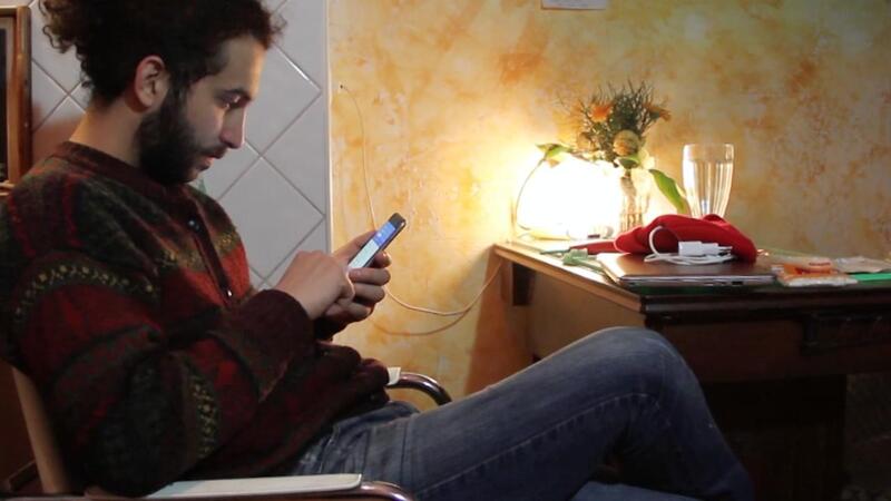 Young man at home looking at his smartphone
